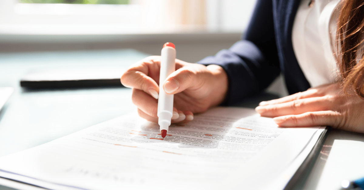 Image of corporate trainer marking paper based assessments